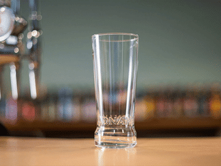 pint glass slowly filling with different colour beers