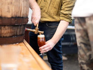 Fergus pouring Extra from a barrel into a glass.