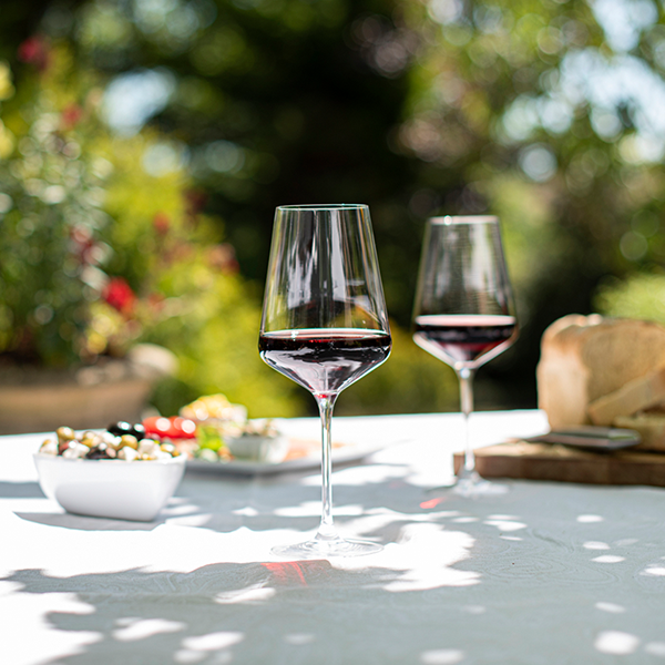Two red wine glasses on a table